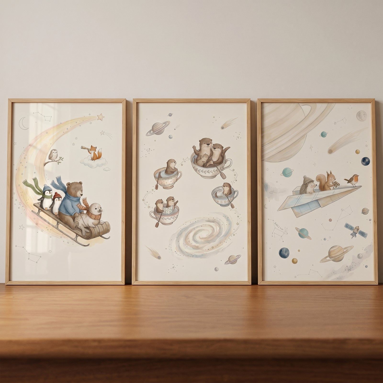 Watercolor starry space animals wall art set of 3 features animals on a moon sled, in teacups, and on a paper airplane.