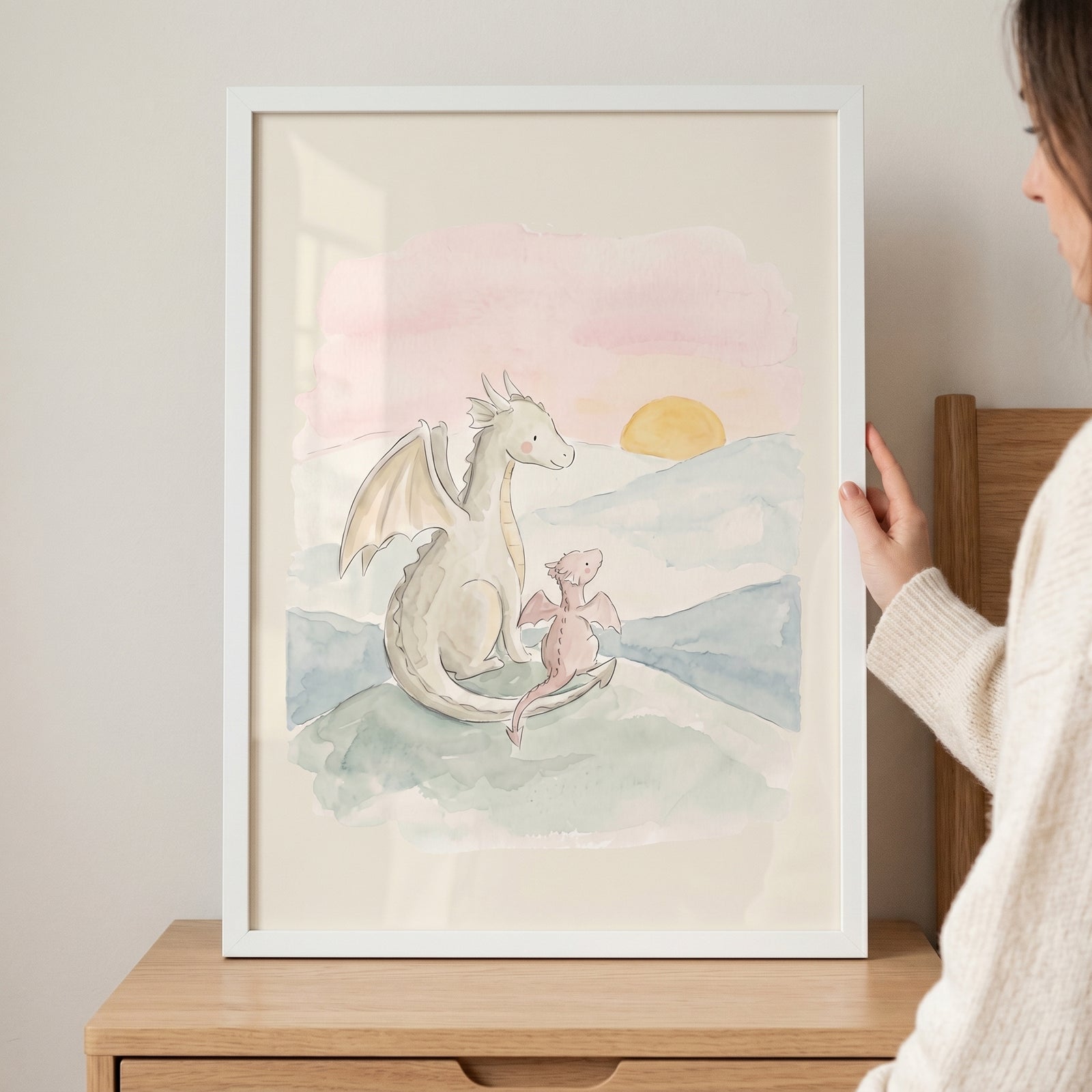 Framed watercolor sunset dragon wall art showing two dragons sitting on a hill watching the sun set over mountains.
