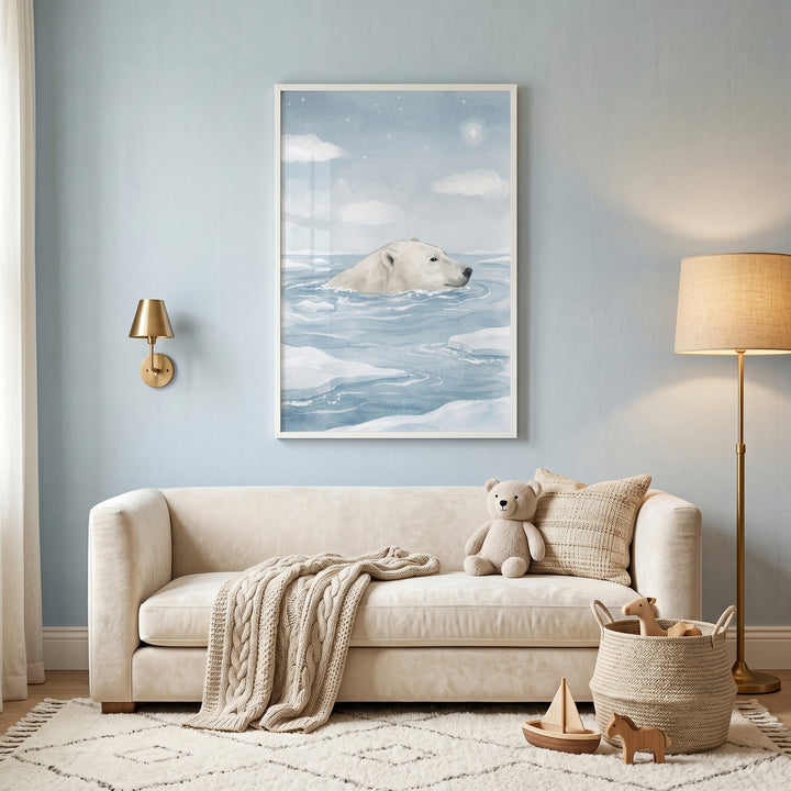 Watercolor swimming polar bear wall art hangs above a cream sofa with a teddy bear, knit blanket, and gold floor lamp.