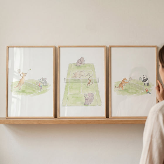 Watercolor tennis playing animals wall art set of 3 with a kangaroo, koala, elephant, hippo, tiger, and panda.