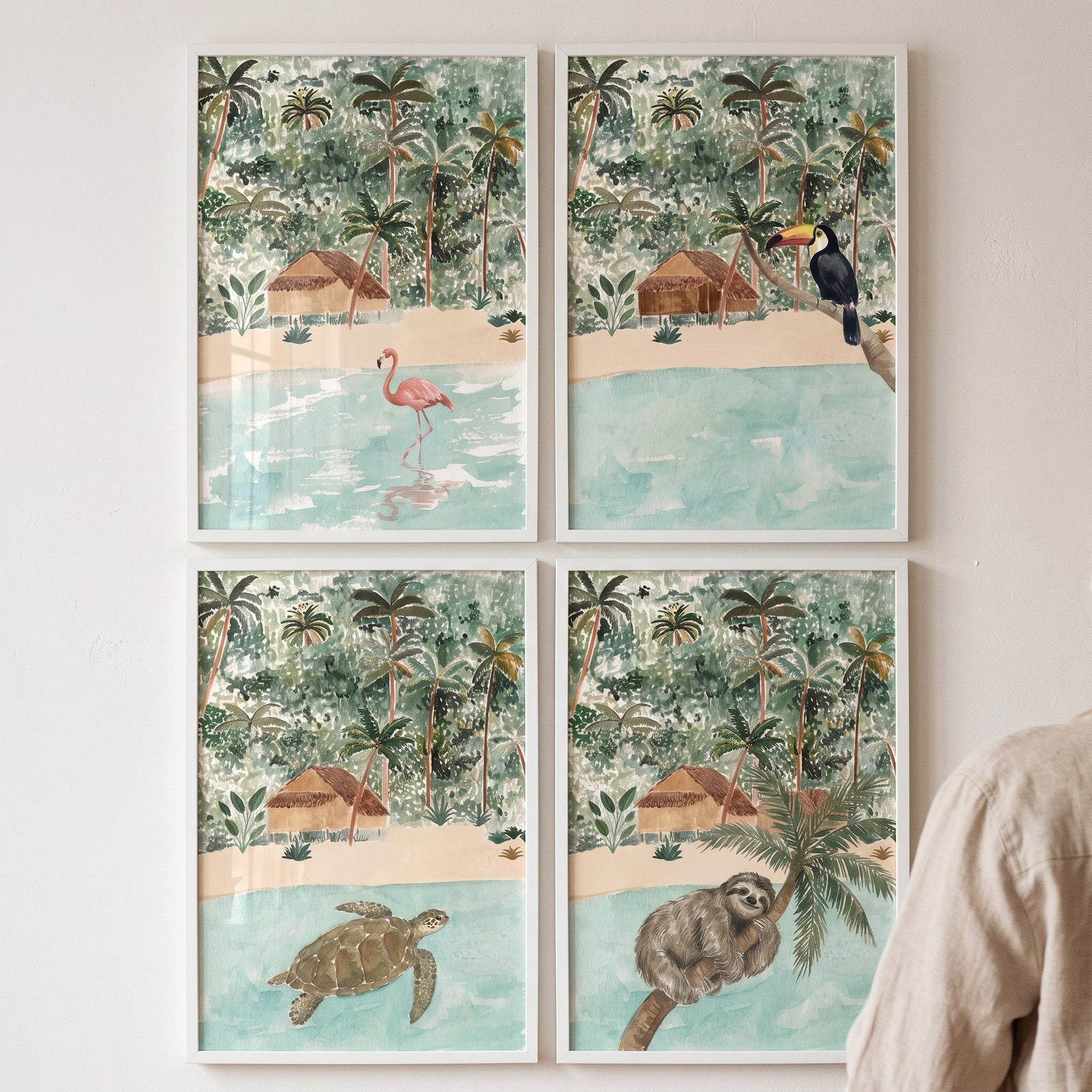 Watercolor tropical island animals wall art set of 4 with a flamingo, toucan, sea turtle, and sloth on a beach.
