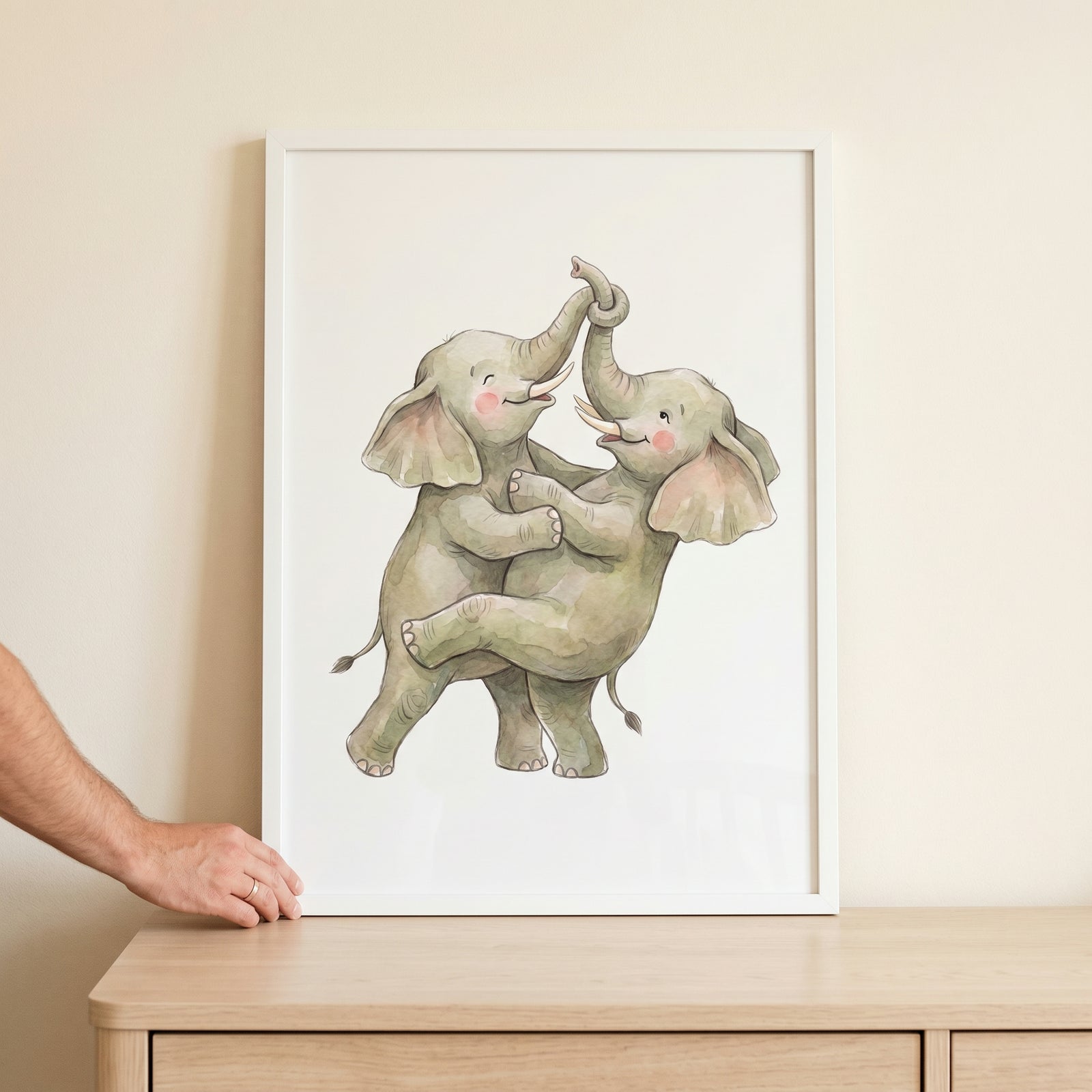 Two playful elephants hug with trunks intertwined in this watercolor trunk link elephant wall art inside a white frame.