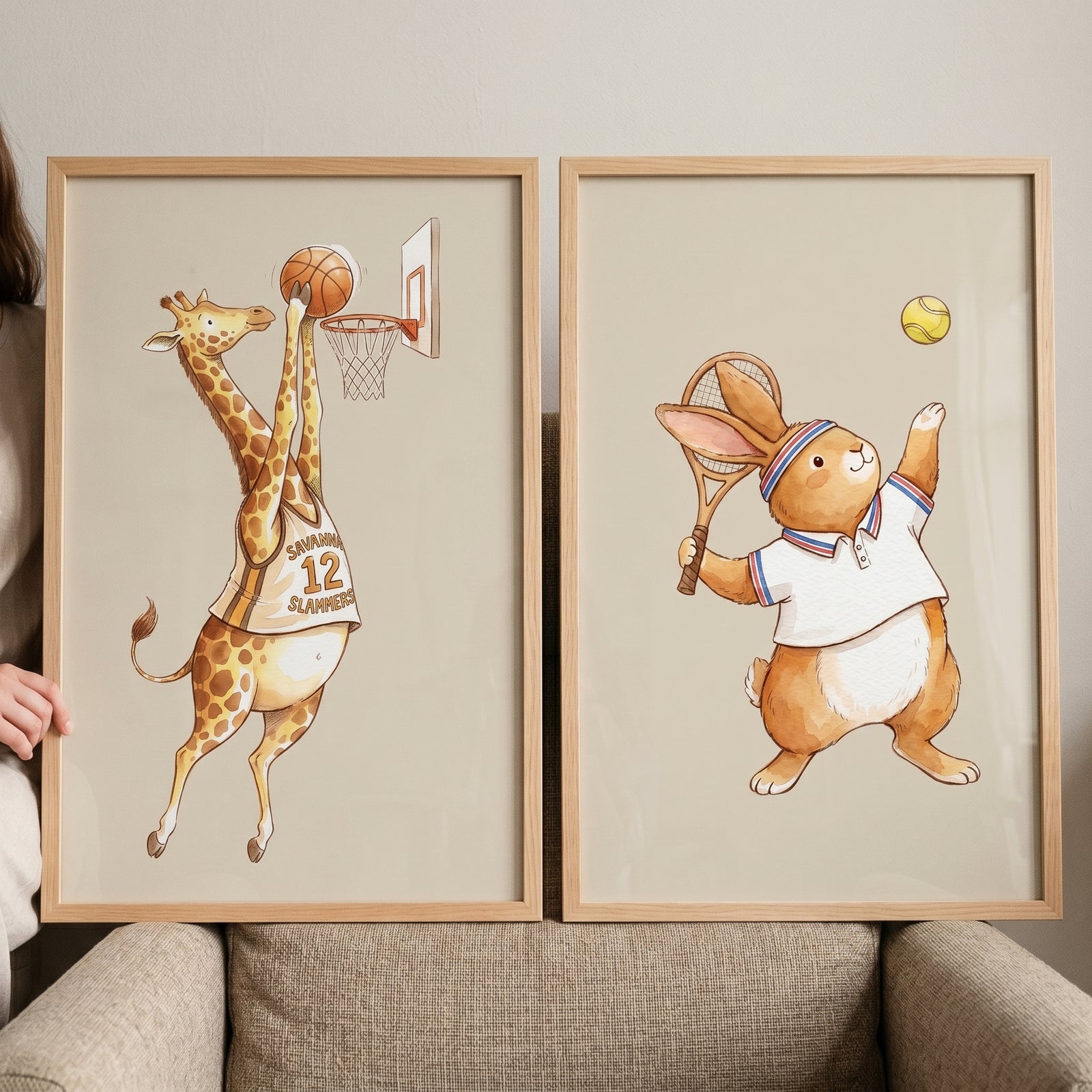 Watercolor whimsical athletic animal wall art set of 2 with a giraffe dunking a basketball and a bunny playing tennis.