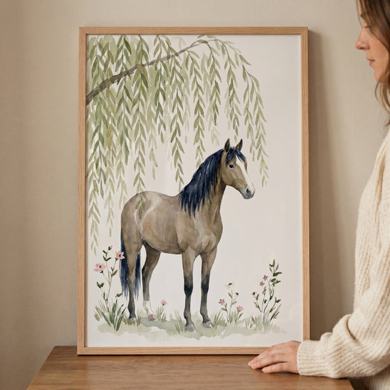 Weeping willow brown horse wall art in a wood frame showing a horse under willow leaves, held by a woman at a table.