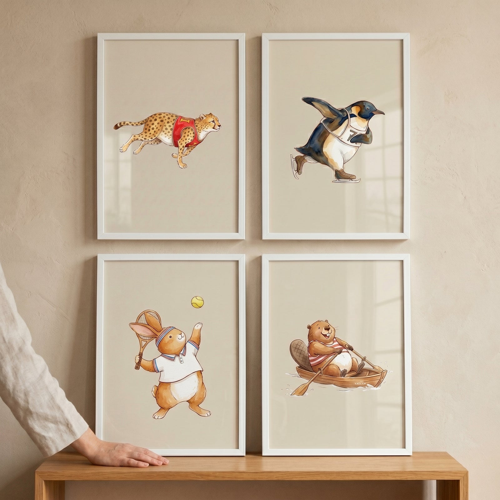Whimsical athletic watercolor animals wall art set of 4 featuring a cheetah, penguin, rabbit, and beaver playing sports.