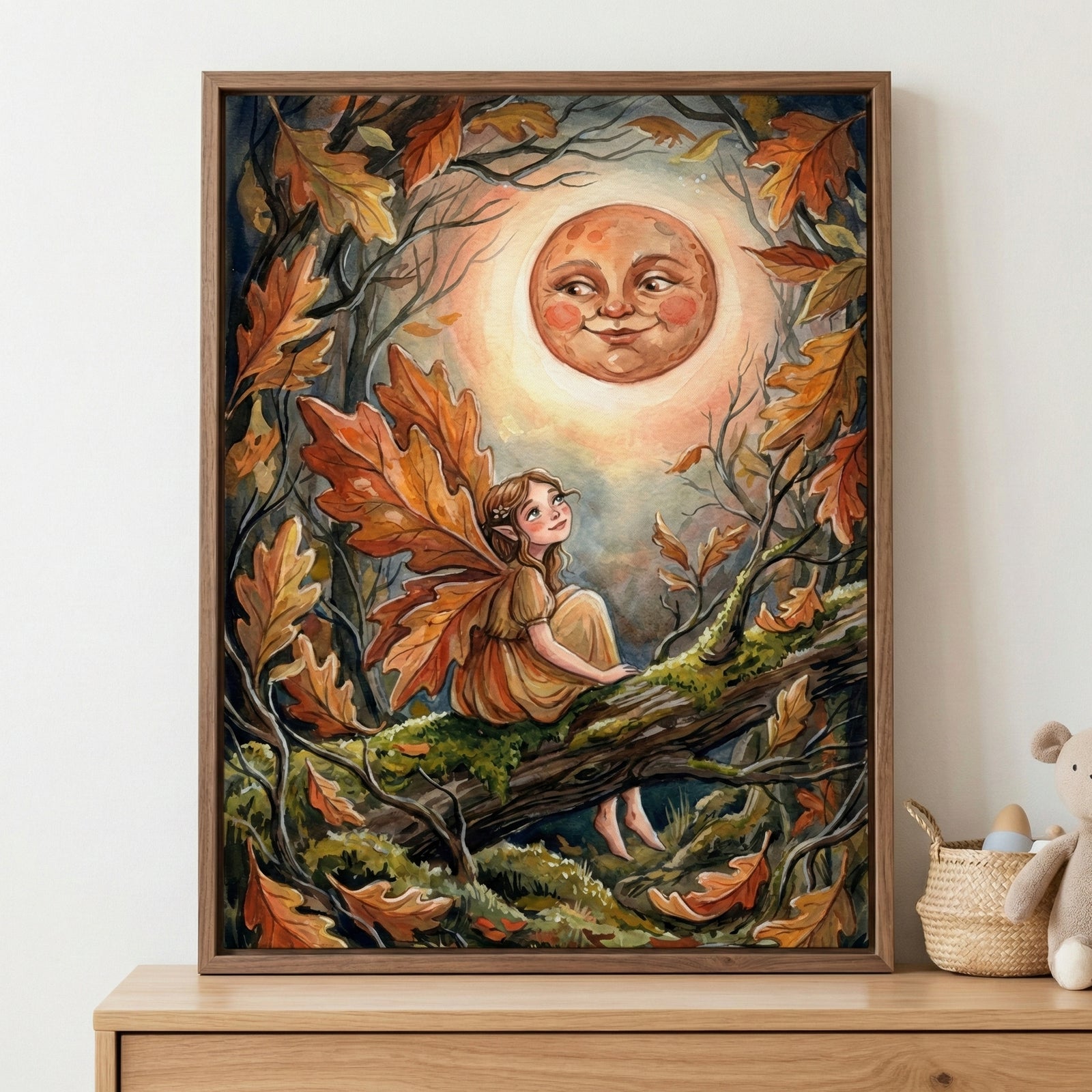 A framed storybook-style illustration of an autumn fairy sitting on a mossy tree branch, surrounded by falling orange leaves and twisting branches, gazing up at a glowing moon with a smiling face, set in a cozy nursery setting with soft, warm tones.