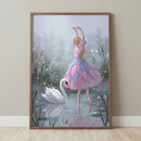 Vertical framed artwork depicting a blonde ballerina in a layered pink and blue feathery tutu. She is shown in a graceful dance pose with her arms raised, standing on the surface of a misty pond. Beside her, a large white swan floats peacefully, its reflection visible in the water. The background features tall reeds, lily pads, and soft, glowing light particles scattered throughout the air. The scene is rendered in a soft, whimsical illustrative style with a pastel color palette.