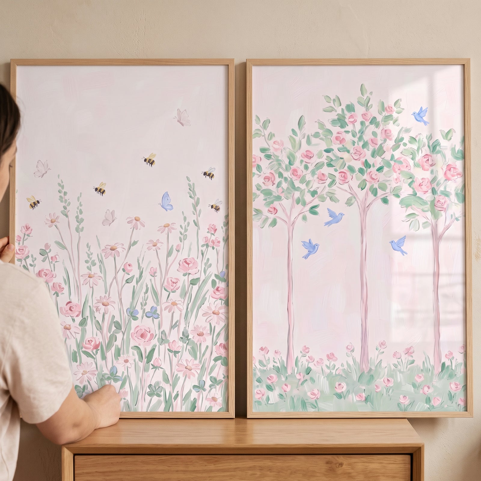 Whimsical blush garden wall art set of 2 featuring soft pink wildflowers, blossom trees, blue birds, and bumblebees.