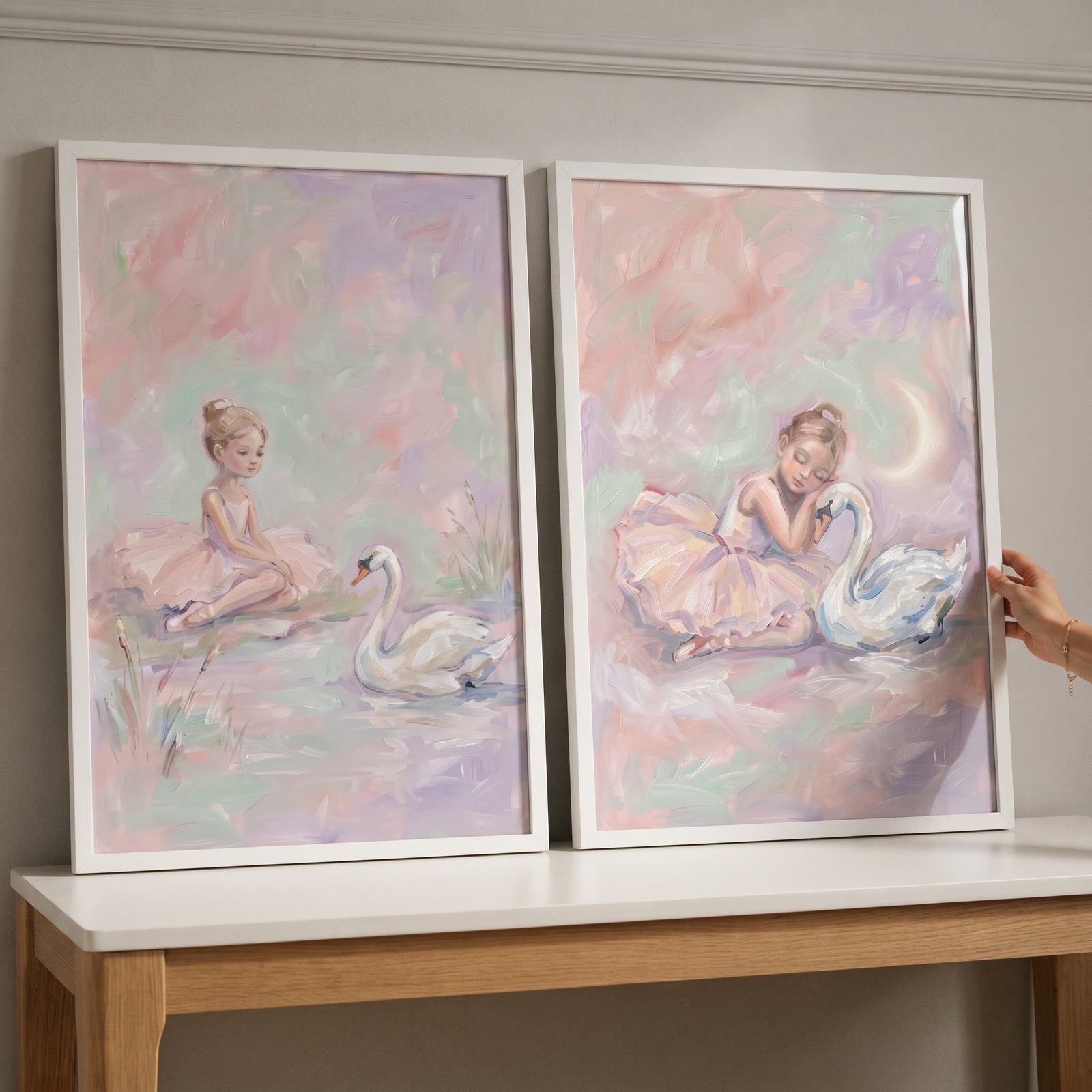 Whimsical blush swan ballet wall art set of 2 depicts a ballerina with a swan in soft, pastel tones.