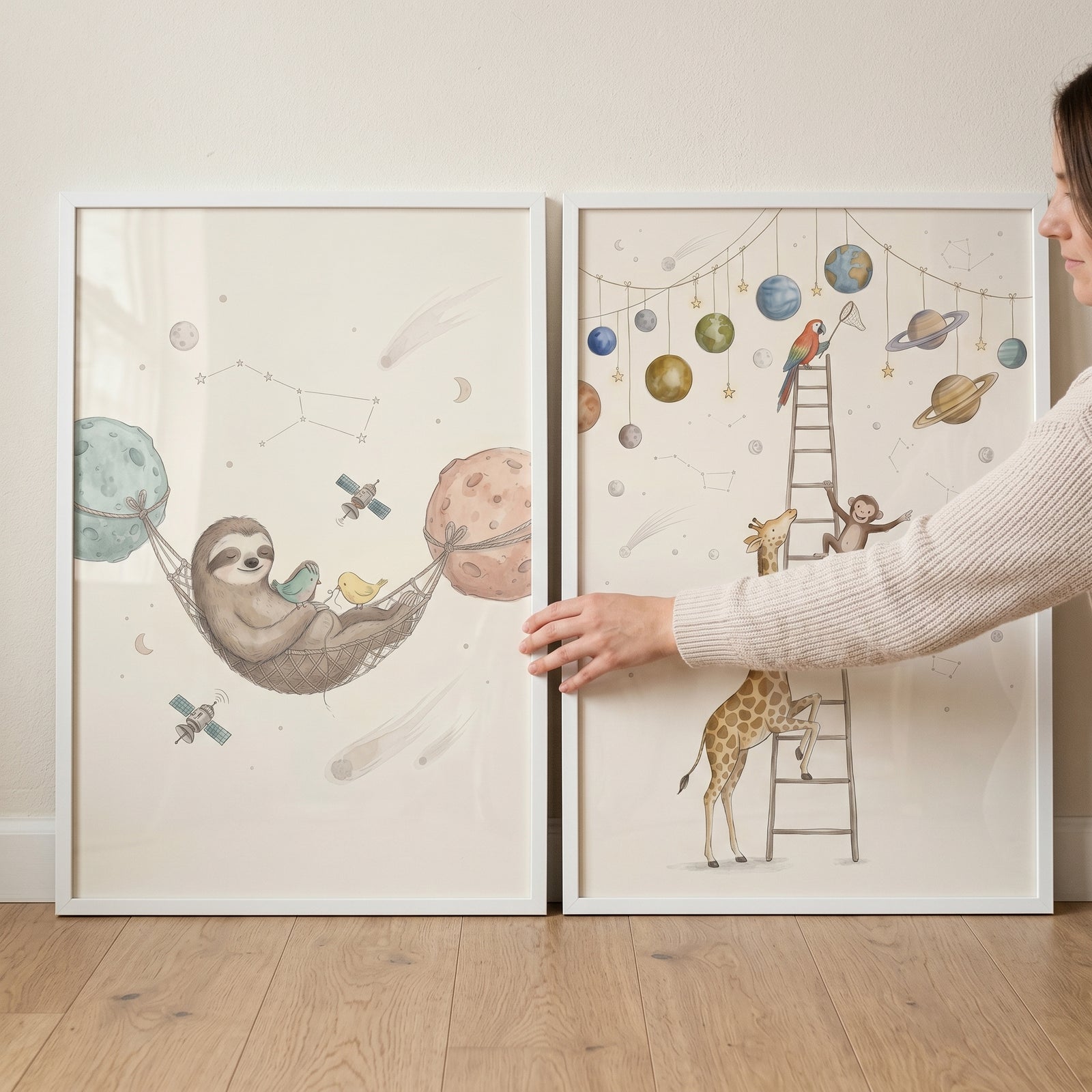 Whimsical celestial watercolor animals artwork set of 2 featuring a sloth in a hammock and a giraffe on a ladder.