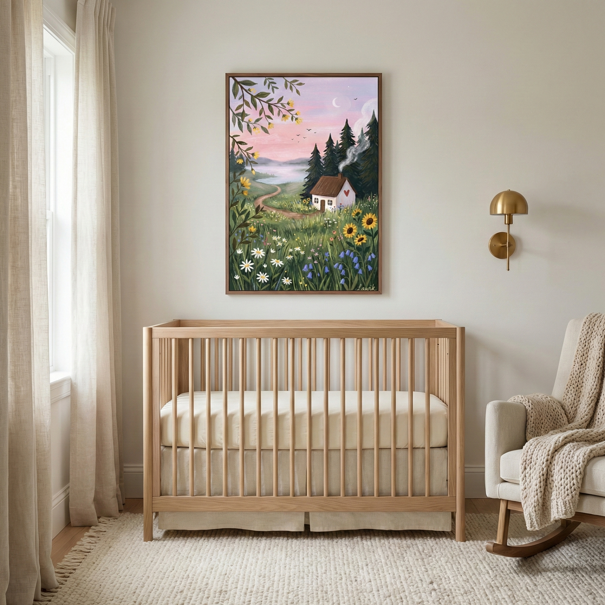 A serene nursery features a light wood crib centered against a neutral wall. Above it, a framed whimsical illustration depicts a white cottage in a meadow of sunflowers and daisies under a soft pink sunset sky with a crescent moon. To the right is a brass wall sconce and a cozy rocking chair draped with a chunky knit throw. The room is completed by a textured cream rug and soft linen curtains. The overall aesthetic is warm and rustic, blending a charming art style with minimalist furniture.