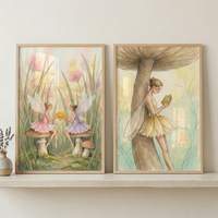 Two framed illustrations sit on a light wood shelf. The left artwork shows two small winged figures on mushrooms in a field of grass and flowers. One wears pink, the other purple, as they hold a golden object. The right piece depicts a winged figure in a yellow dress leaning against a large mushroom while reading a book. Both feature muted colors and delicate lines. The frames are light wood. To the left, a small vase holds dark sprigs.