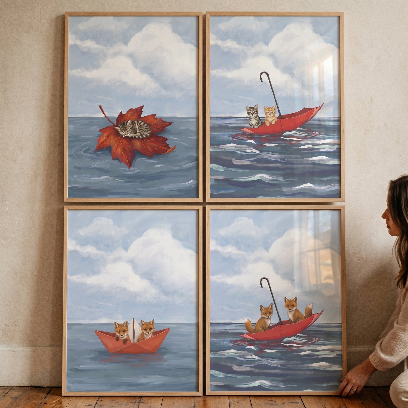 Whimsical floating baby animals wall art set of 4 with kittens and foxes in umbrellas, a paper boat, and on a leaf.