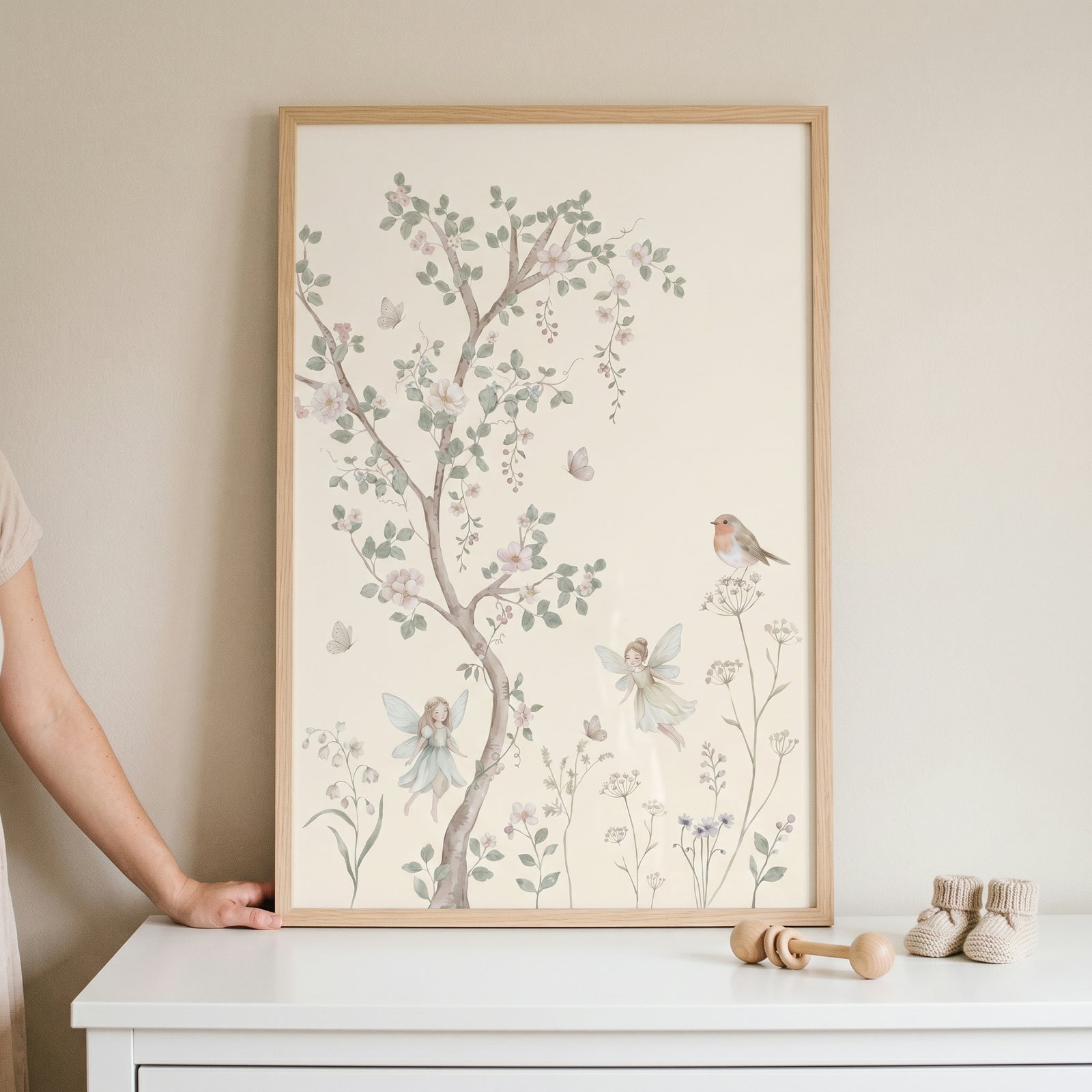 Whimsical flying garden fairies wall art in a wood frame displays a delicate tree, a small bird, and pastel garden blooms.