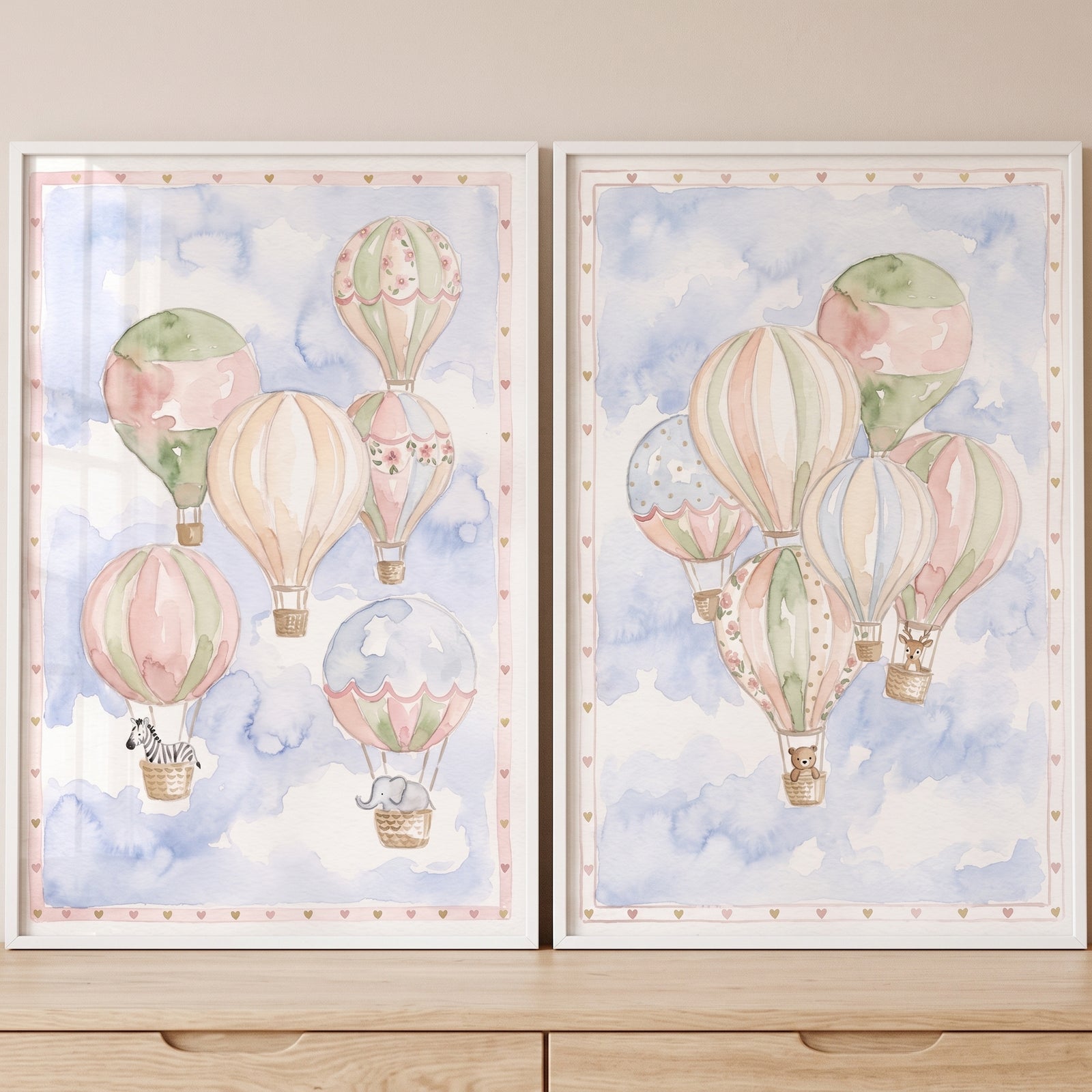 Whimsical hot air balloon wall art set of 2 features animals in baskets drifting through a soft blue watercolor sky.