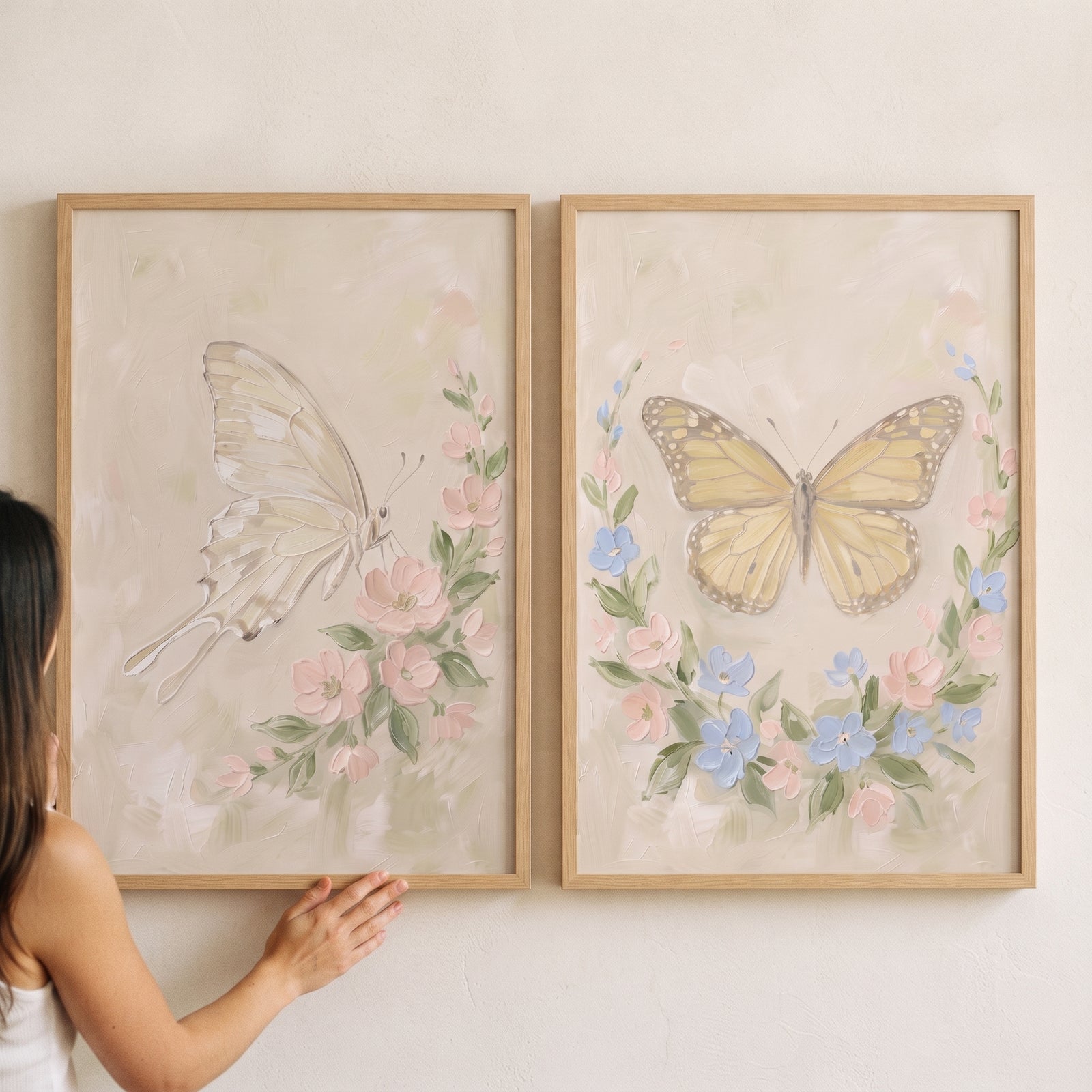 Whimsical impasto botanical butterfly wall art set of 2 shows soft winged insects and floral wreaths in wood frames.