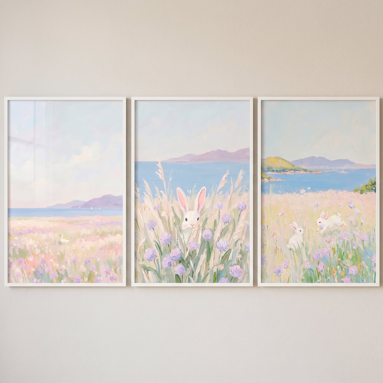 Whimsical lilac coastal meadow wall art set of 3 featuring white rabbits and a bird among wildflowers by the sea.