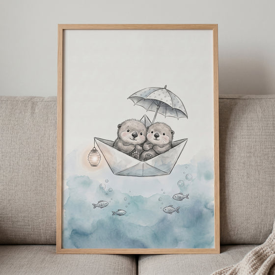 Whimsical paper boat otters wall art features two otters under an umbrella floating on watercolor blue waves with fish.