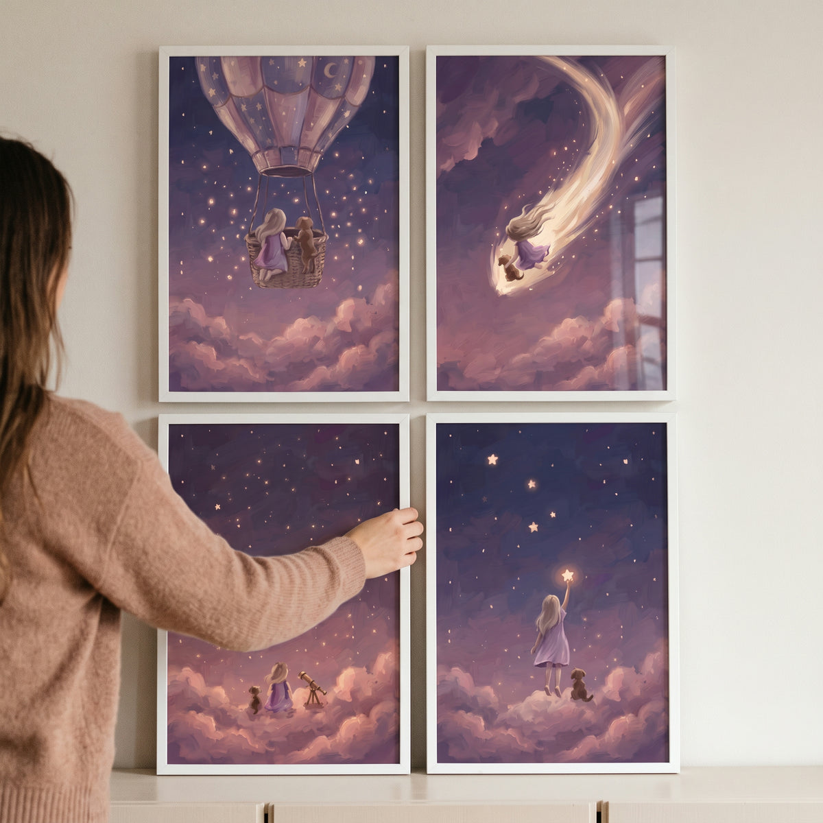 Person hangs a whimsical purple girl dog wall art set of 4 with magical scenes of a girl and pet in the starry sky.