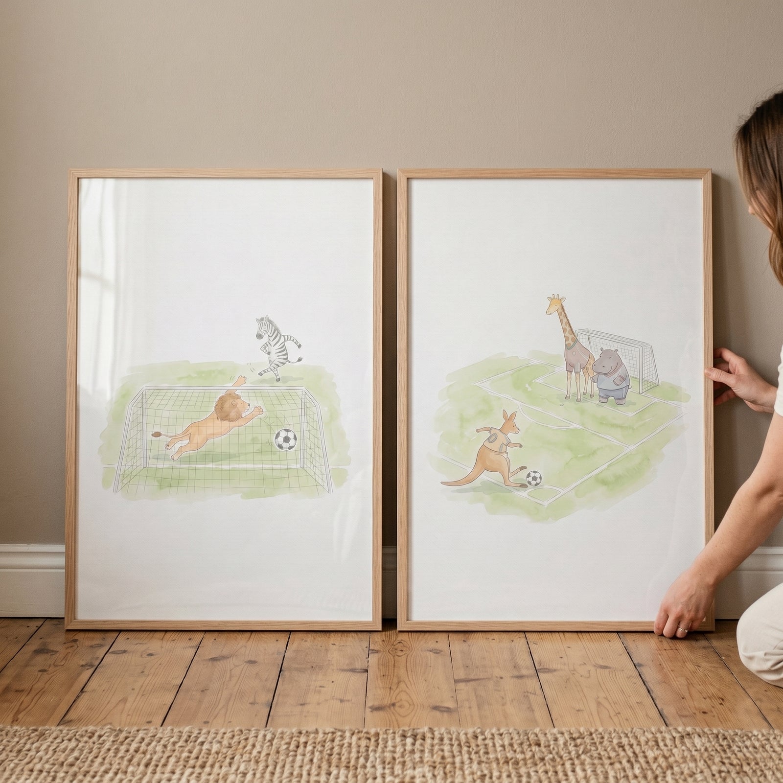 Whimsical soccer safari animals wall art set of 2 with lion, zebra, giraffe, and kangaroo playing soccer in wood frames.