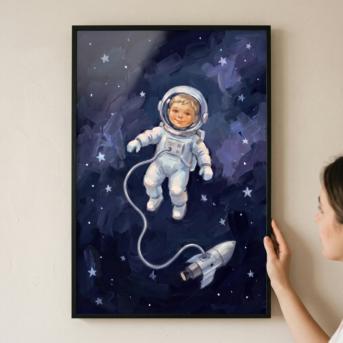 Whimsical space baby astronaut wall art shows a smiling child in a white spacesuit floating among stars in the deep blue sky.