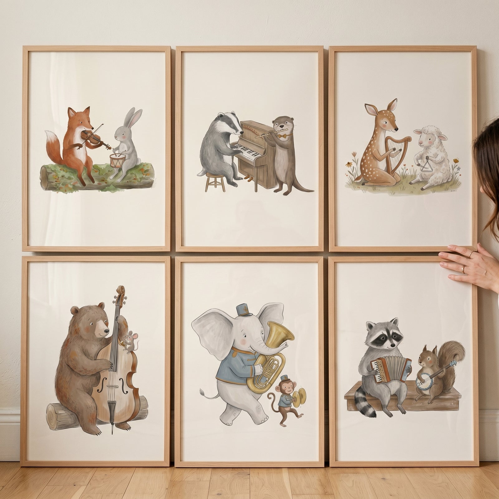Whimsical storybook forest animal wall art set of 6 with watercolor animals playing musical instruments in wood frames.