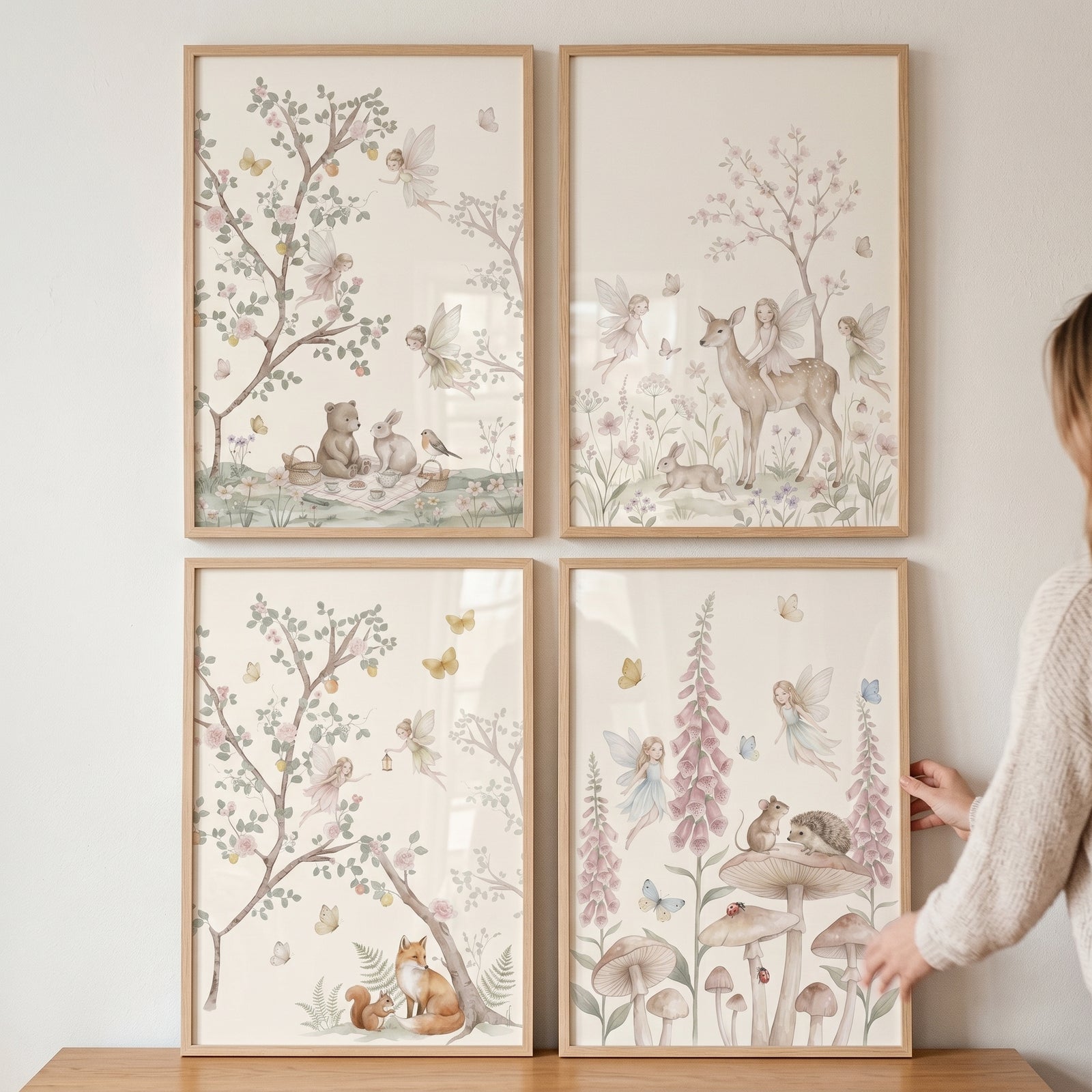 Whimsical storybook woodland fairies wall art set of 4 depicts gentle forest animals and winged figures in nature scenes.