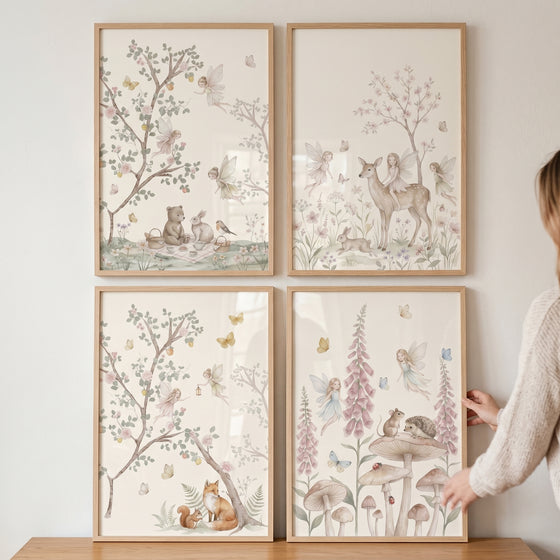 Whimsical storybook woodland fairies wall art set of 4 depicts gentle forest animals and winged figures in nature scenes.