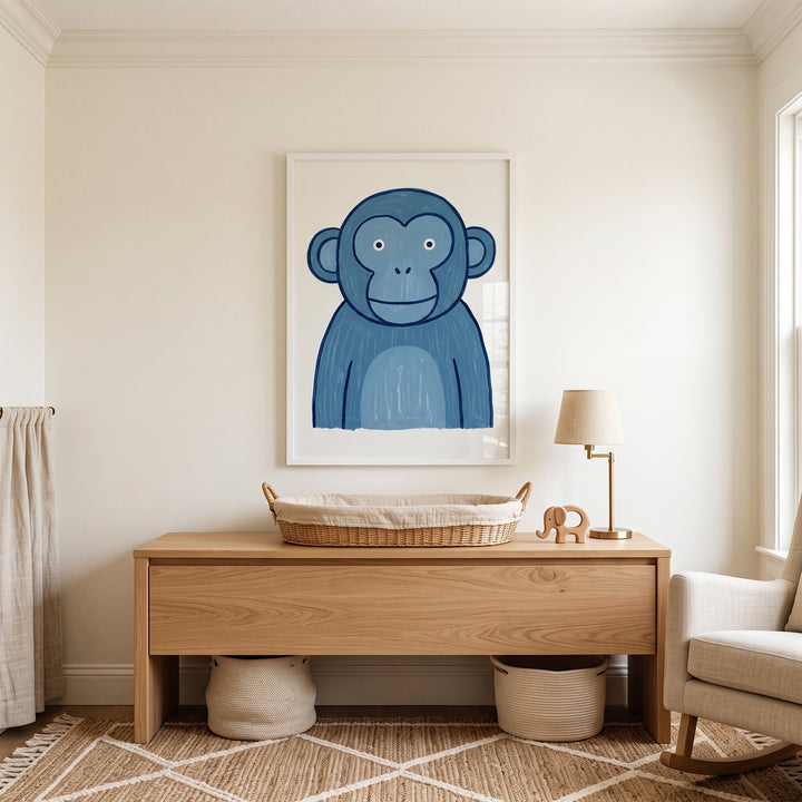 Whimsical teal blue monkey wall art hangs over a wooden changing table in a neutral nursery with a lamp and rocking chair.