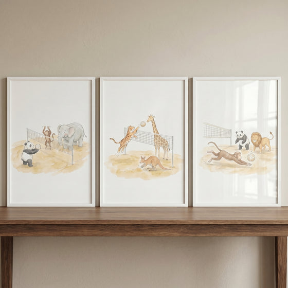 Whimsical watercolor volleyball animals wall art set of 3 shows framed prints of zoo animals playing beach volleyball.