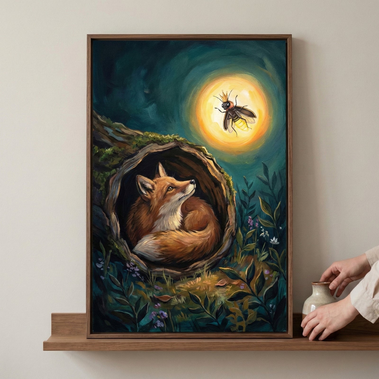 A framed storybook-style illustration of a fox curled inside a hollow tree at night, gazing up at a glowing crowned firefly floating in a warm golden halo, surrounded by deep teal shadows, woodland plants, and soft, magical lighting that creates a calm, dreamy forest scene.