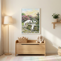 A bright, neutral-toned room features a framed watercolor illustration of three white dogs at a stone garden fountain surrounded by pink flowers. The art hangs above a light wood toy chest. On the chest, a wicker basket holds wooden blocks next to a plush stuffed bunny. A tall floor lamp with a beige shade stands to the left, and a small wall shelf with a potted plant is to the right. The scene is finished with a pastel striped rug on the floor.
