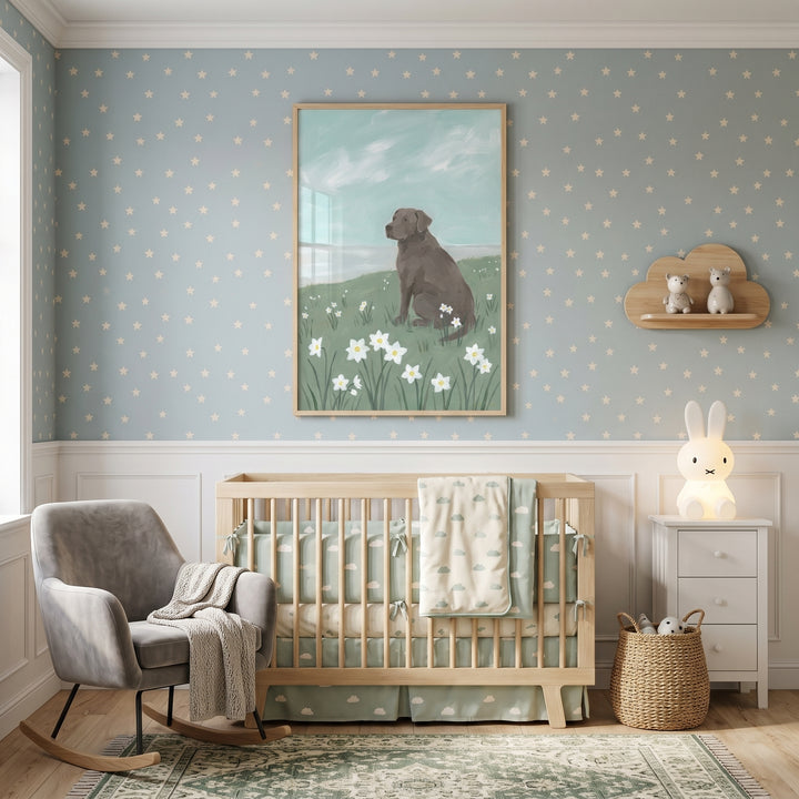 Nursery with blue star wallpaper, white flower chocolate labrador dog wall art, wood crib, rocking chair, and bunny lamp.