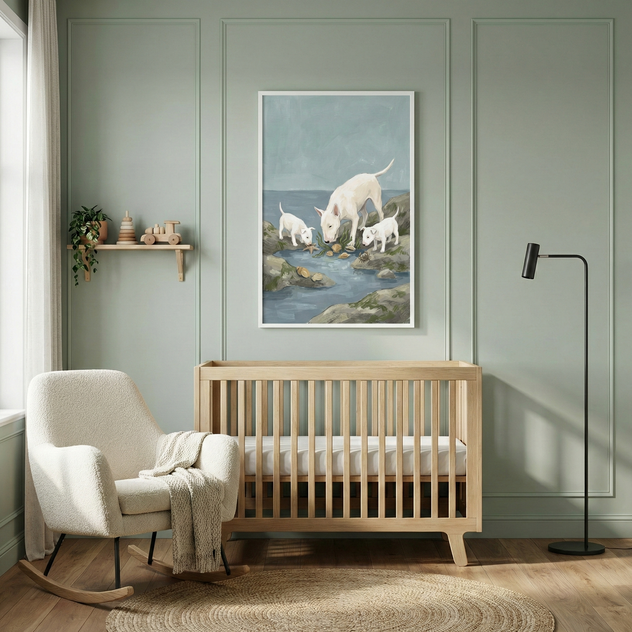 A peaceful nursery with sage green paneled walls. A light wood crib is centered, with a framed artwork hanging above it depicting three white dogs on a rocky shore. To the left sits a white bouclé rocking chair with a beige throw. A small wooden shelf above it holds a plant and toys. On the right stands a tall, slim black floor lamp. A round jute rug is placed on the light wood floor, completing the neutral and calming space.