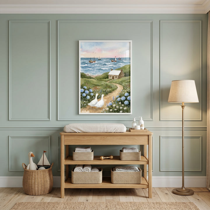 Green paneled nursery with white roof stone cottage wall art above a wooden changing table and a floor lamp.