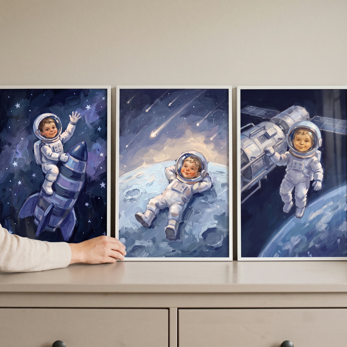 White spacesuit baby astronaut wall art set of 3 features a child on a rocket, on the moon, and near a space station.