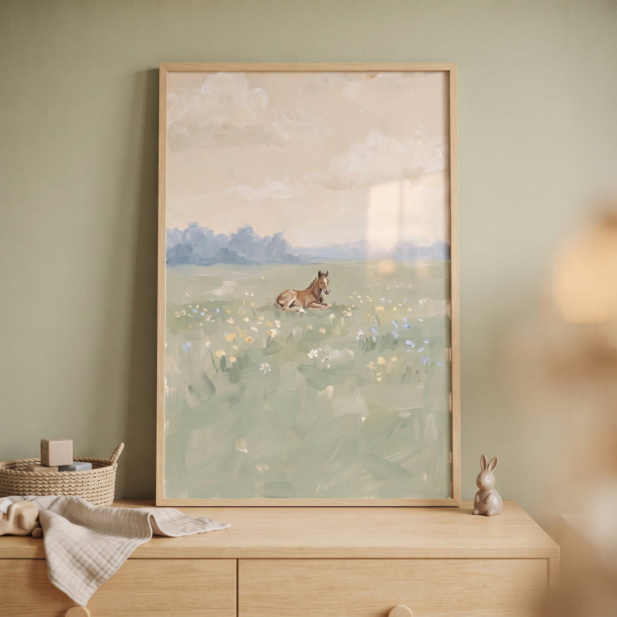 A brown foal rests among yellow and blue flowers in this wildflower meadow resting horse wall art.