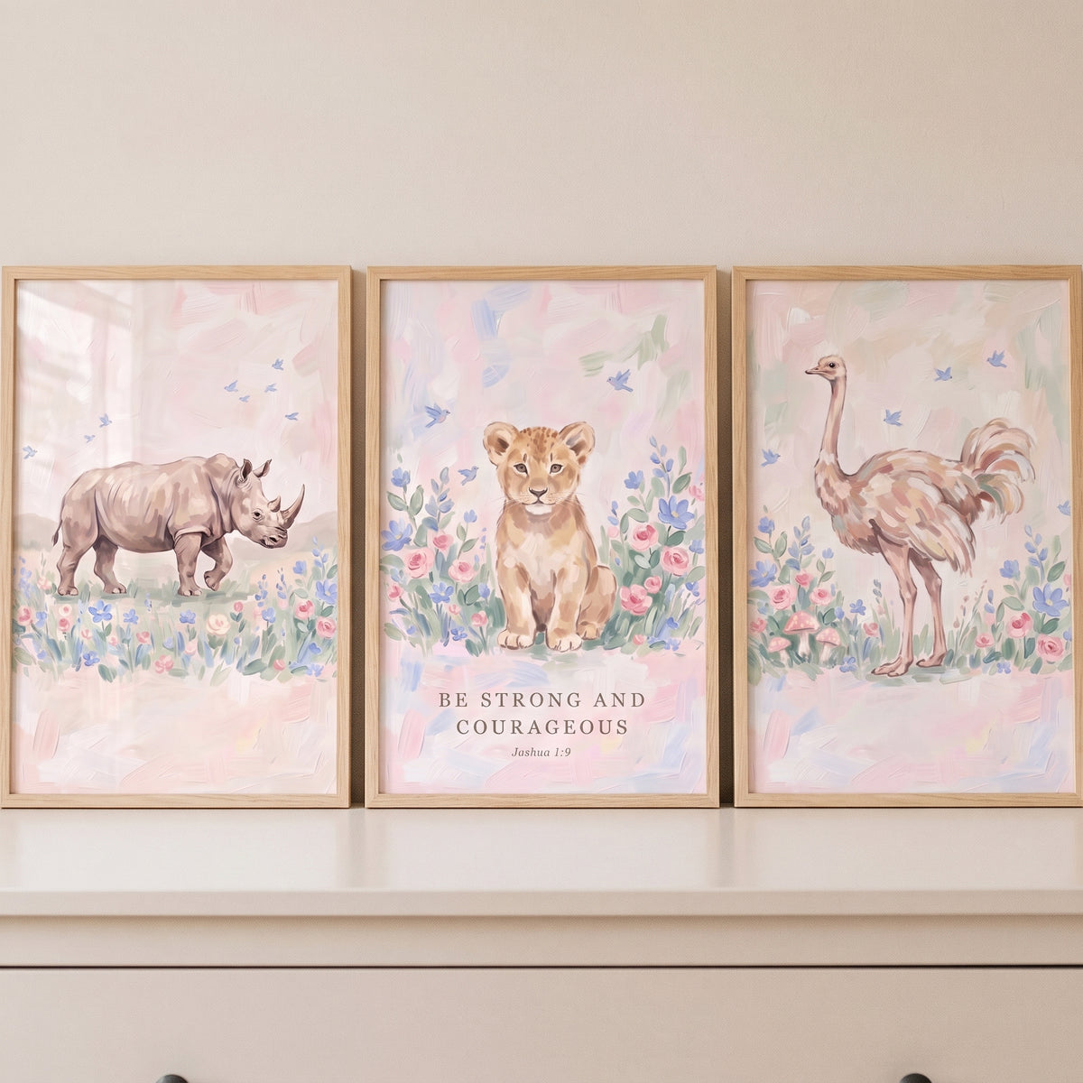 Wildflower pink savanna animals wall art set of 3 with a rhino, lion cub, and ostrich featuring scripture in wood frames.