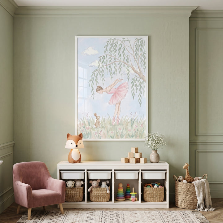 Willow tree pink ballerina wall art hangs in a sage green nursery with a pink armchair and toys in white storage bins.