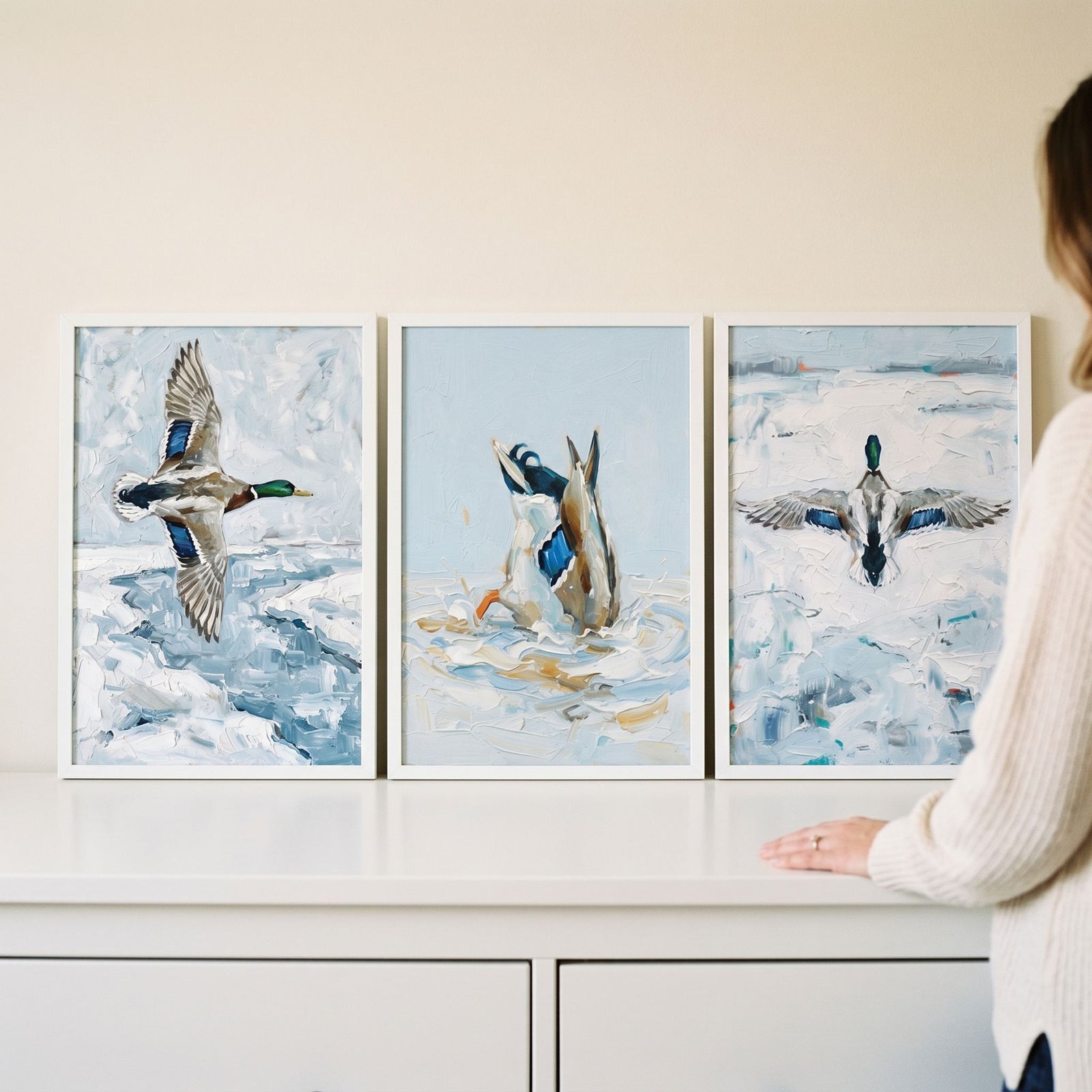 Winter landscape mallard duck wall art set of 3 features textured ducks flying and diving over icy water.