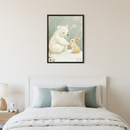 Kid's bedroom with a white bed. A framed watercolor art print of a polar bear and a rabbit in a snowy scene hangs centered above the bed. A nightstand with a lamp and a small white teddy bear is beside the bed.