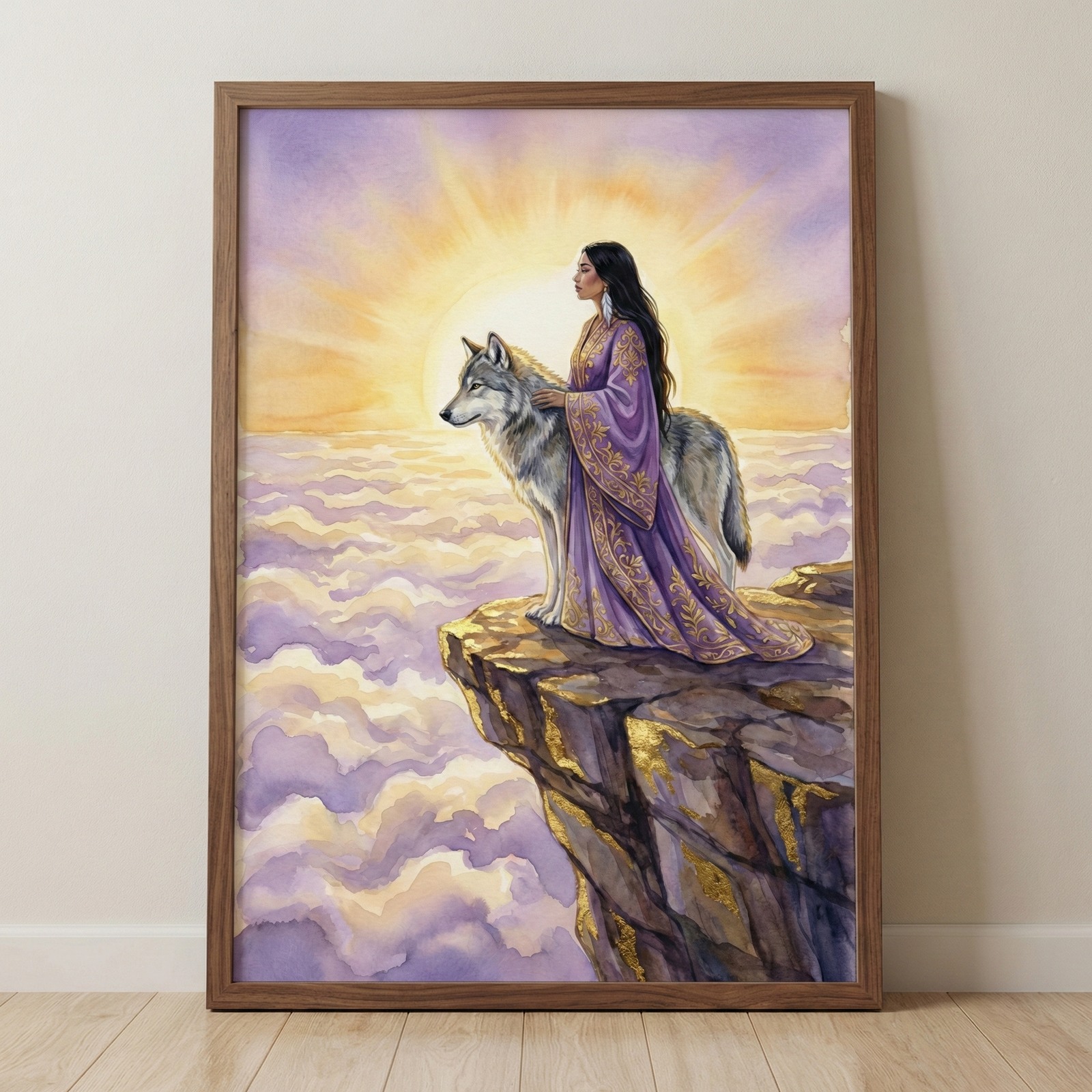 A framed watercolor-style illustration depicts a woman and a wolf standing together on a rocky cliff's edge. The woman, with long dark hair, wears a flowing purple robe adorned with intricate gold embroidery. She rests a hand gently on the back of a large grey and white wolf. They overlook a vast sea of purple and white clouds. Behind them, a bright yellow sun radiates light, creating a glowing halo. The cliff has subtle gold highlights. The wooden frame rests against a neutral wall.