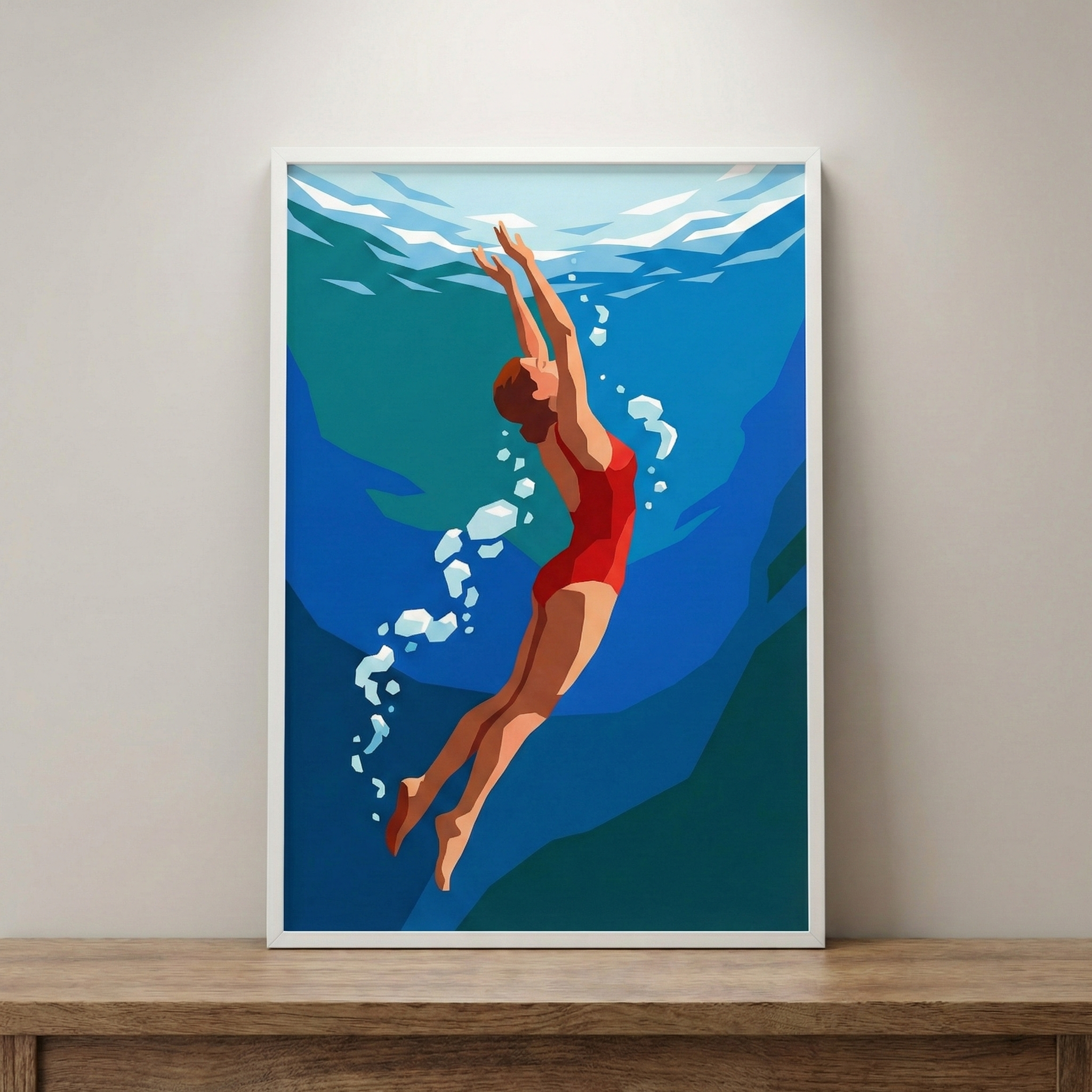 A framed graphic print hangs on a light-colored wall, positioned above a wooden surface. The illustration depicts a minimalist, stylized scene of a person swimming upward through deep blue water. The swimmer is shown in profile, wearing a bright red one-piece swimsuit, with arms extended gracefully toward the surface.
