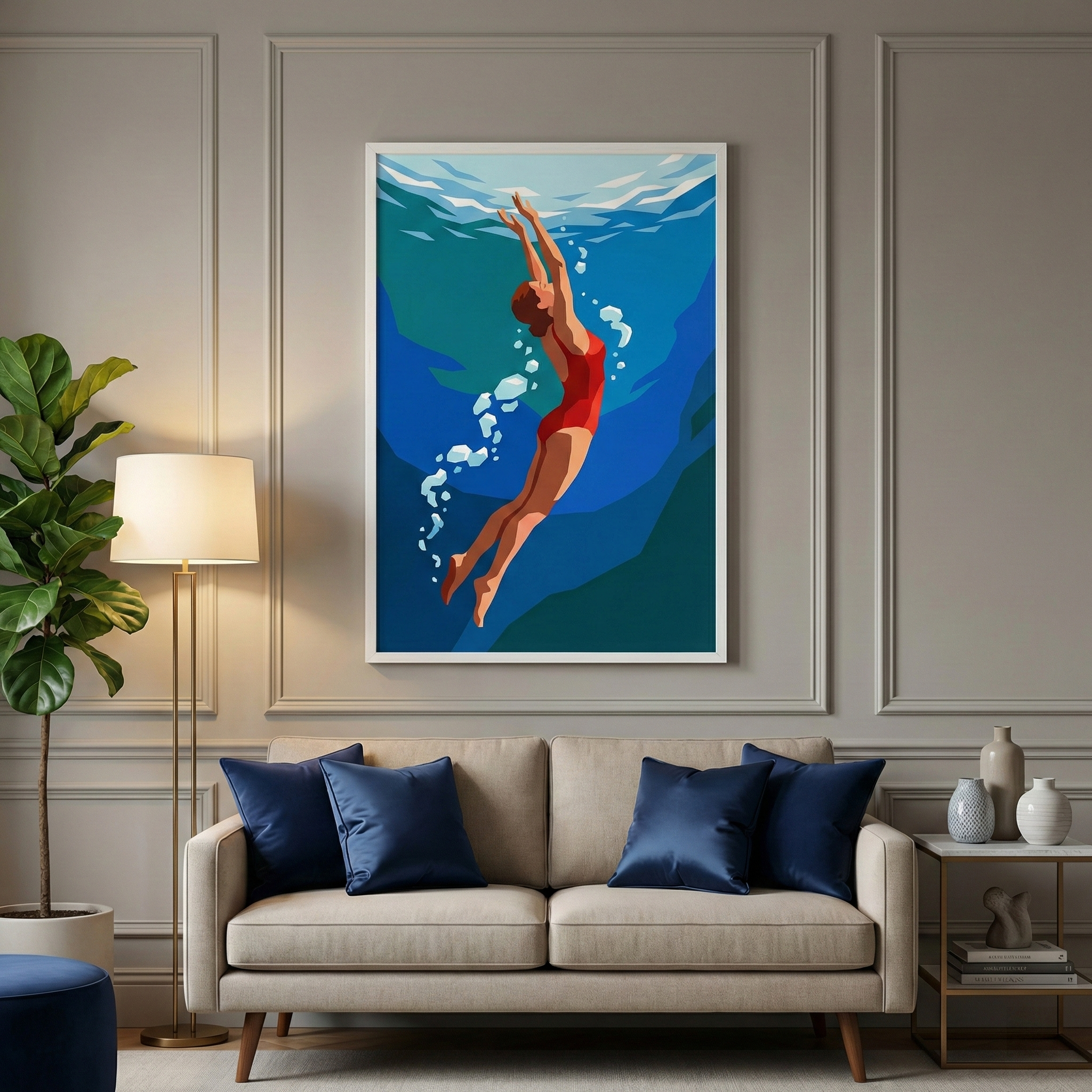 A contemporary living room setup featuring a large framed graphic illustration centered on a grey-toned wall with decorative molding. The artwork depicts a figure in a vibrant red swimsuit swimming upwards through layered shades of blue water, accompanied by a trail of white bubbles. Beneath the art sits a light beige sofa decorated with four navy blue cushions. To the left, a sleek floor lamp with a white lampshade stands next to a lush green indoor plant. 