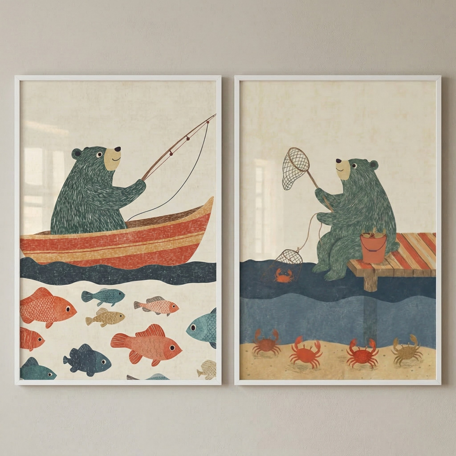 Two framed children’s prints hang side by side on a wall. One shows a green bear fishing from a striped boat surrounded by colorful fish, and the other shows the same bear sitting on a dock with a crab net above the water while crabs move along the sandy bottom.