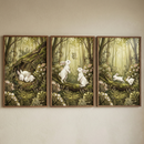 Three framed vertical illustrations are displayed side-by-side as a triptych on a neutral wall. Each panel depicts a whimsical woodland scene featuring small white rabbits in a lush forest of green, brown, and golden tones. The left illustration shows two rabbits sleeping together inside a hollowed log. The center piece depicts two rabbits standing on their hind legs on a fallen branch, watching a butterfly. The right panel shows two rabbits hopping across a mossy log. The style is reminiscent of storybook 