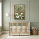 A cozy nursery features a light wooden crib against a soft green wall, adorned with a charming painting of a rabbit among flowers. A floor lamp with a beige shade stands nearby, and a wicker basket holds rolled-up blankets, creating a serene and inviting atmosphere.