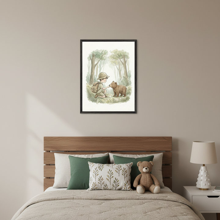 Kid's bedroom with a wooden bed and beige bedding. A black-framed watercolor illustration hangs centered above the bed, showing a child in a safari hat interacting with a bear cub in a forest. A teddy bear sits on the bed, and a white lamp is on a nightstand.