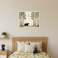 Kid's bedroom with a wooden bed, yellow tree-patterned duvet, and bedside table. A framed painting of a black bear walking in a forest with tall trees and a golden sun hangs centered above the bed.