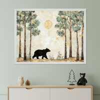 Modern kid's room with a light wood dresser. A large white framed painting of a black bear walking through a forest with tall trees and a golden moon, in an illustrative style, hangs centered above the dresser. On the dresser are an owl figurine, a pinecone, a metal tree, and a black teddy bear.